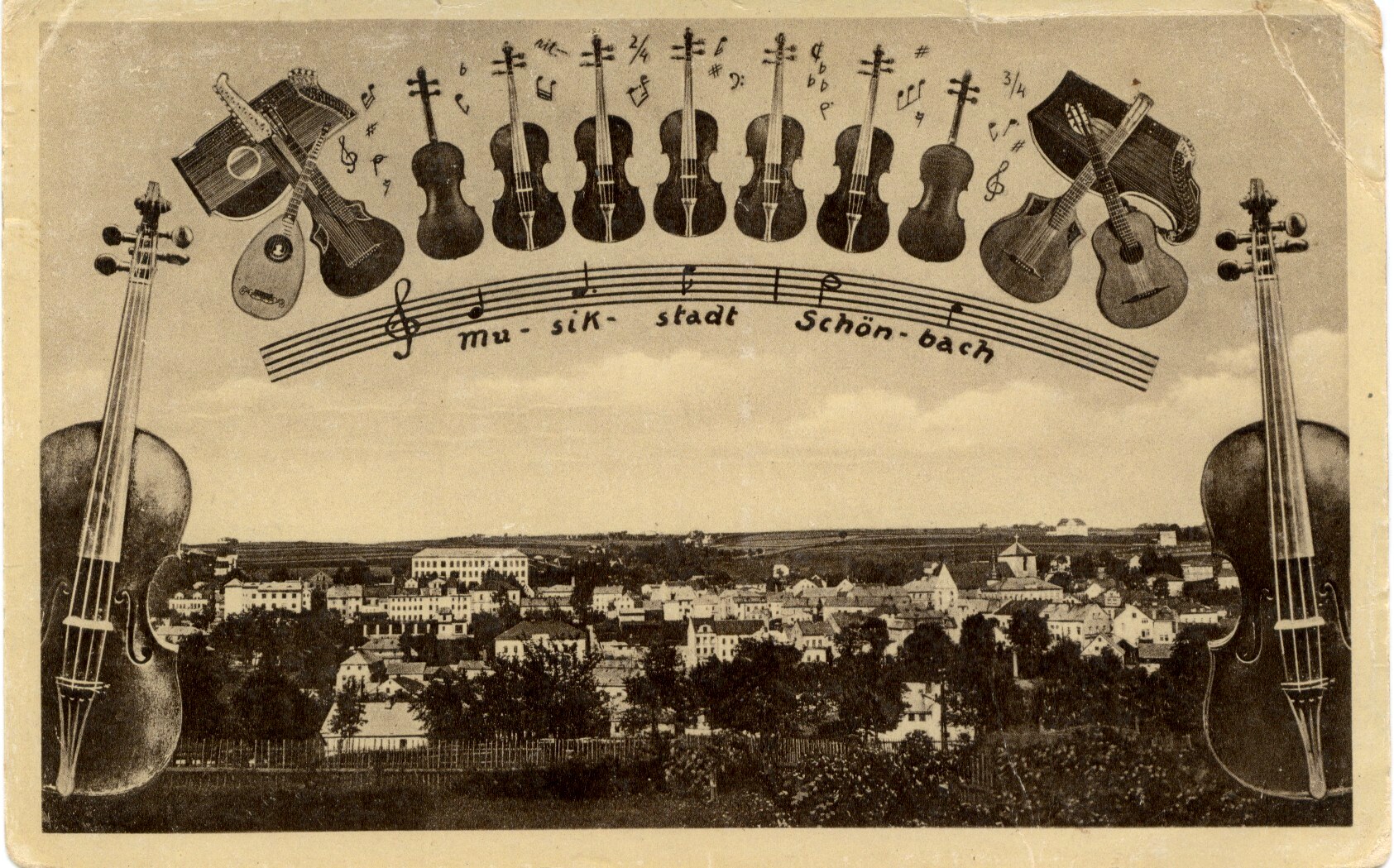 Sepia vintage postcard of Schönbach framed by musical instruments: an arch of upright violins over a staff reading “mu-sik-stadt Schön-bach,” guitars and other instruments at the sides, and a wide view of the town’s rooftops and fields between two large upright string basses.